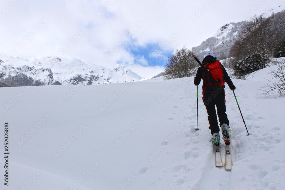 girl doing touring ski in a mountain covered of snow