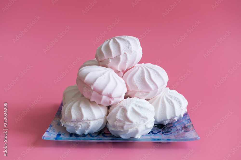 Pink and white marshmallows on a pink background Pink and white marshmallows on a pink background