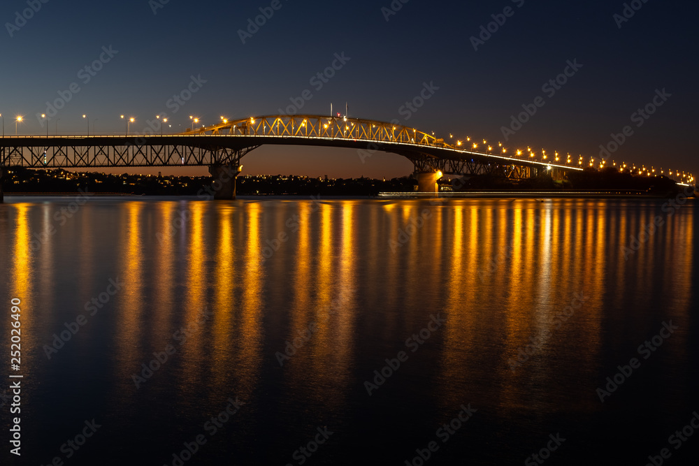 The Auckland harbour bridge lit up at night
