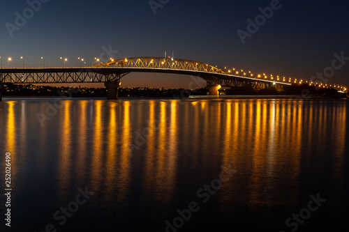 The Auckland harbour bridge lit up at night © Wise Dog Studios