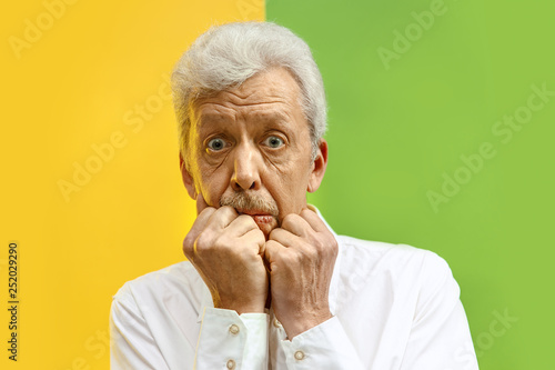Wow. The senior male portrait on color studio backgroud. emotional surprised bearded man. Human emotions  facial expression concept. Trendy colors