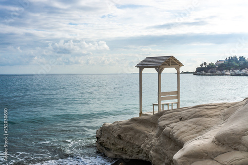 Arbor on the rock near the beach with beautiful waves. Cyprus, February 2019.