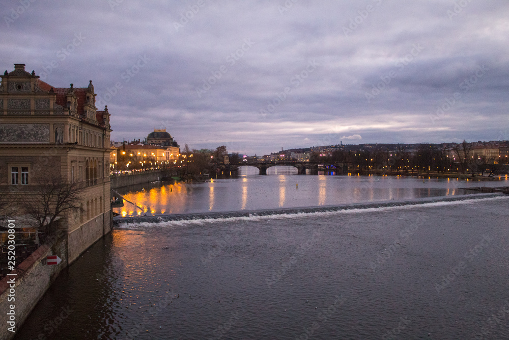 Bright lights of evening Prague, cityscape of Prague bridges, view of Charles Bridge