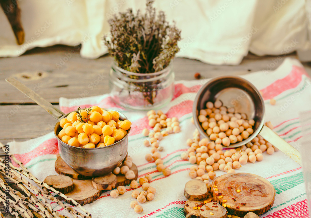 Dried and boiled chickpeas. Vegetarian protein. Dry thyme sprigs in a jar. Healthy lifestyle and balanced food concept. Selective focus. Dried and boiled chickpeas. Vegetarian protein. Dry thyme sprigs in a jar. Healthy lifestyle and balanced food concept. Selective focus.