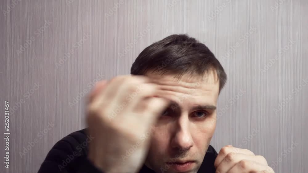 Confident boxing man holding fists in front of him, going to fight and defend himself, ready for fighting Confident boxing man holding fists in front of him, going to fight and defend himself, ready for fighting