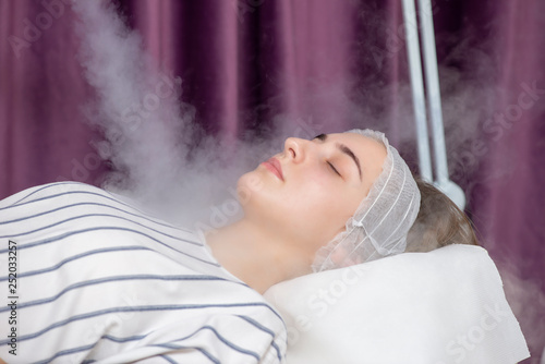Beauty treatment of young female face, ozone facial steamer