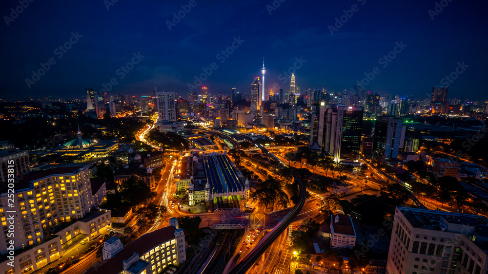 Cloudy sunset over Kuala Lumpur City Skyline showing the transportation arteries withing the heart of the city's transportation hub.