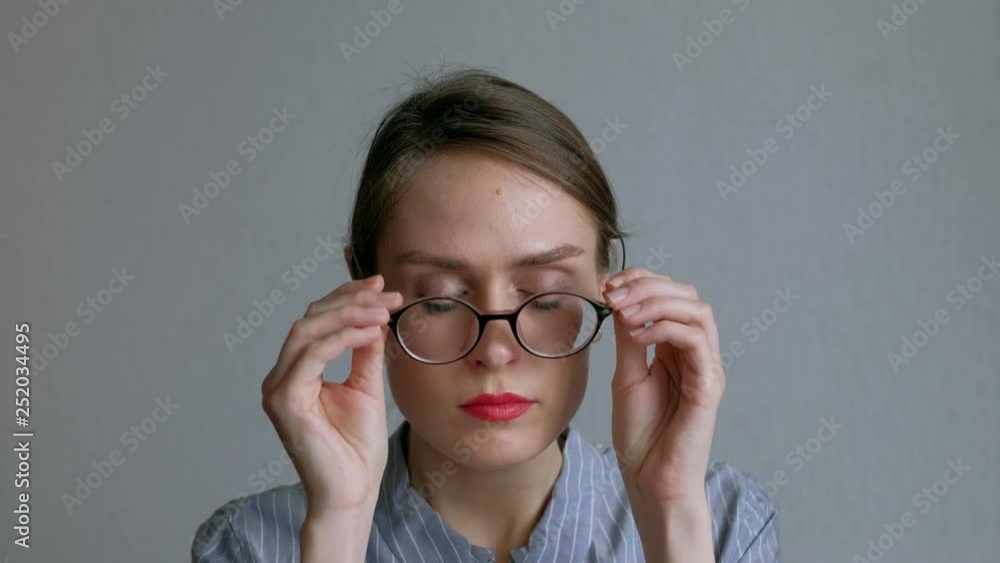 Woman with black glasses relaxes with head massager. Alternative Therapy. Indian head massage tool, self head massager. Woman with black glasses relaxes with head massager. Alternative Therapy. Indian head massage tool, self head massager.