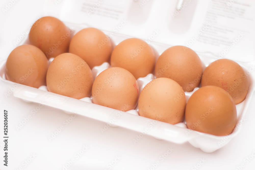 Brown chicken eggs in box on white background Brown chicken eggs in box on white background