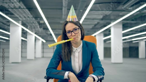 A clerk throws confetti while blowing a whistle. Lonely birthday concept.