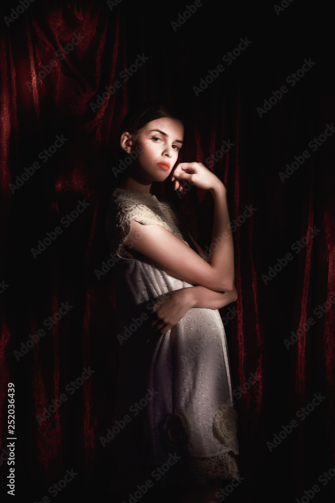 Beautiful woman in white dress on dark burgundy background Beautiful woman in white dress on dark burgundy background