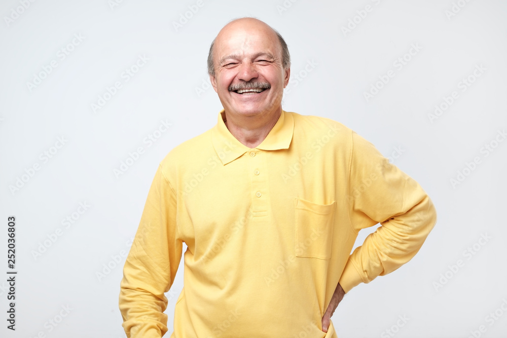 Mature adult man laughing looking at the camera over white background. Mature adult man laughing looking at the camera over white background.