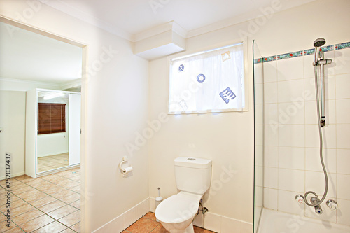 Small bathroom with toilet and glass shower