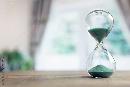 Hourglass time passing in room by window