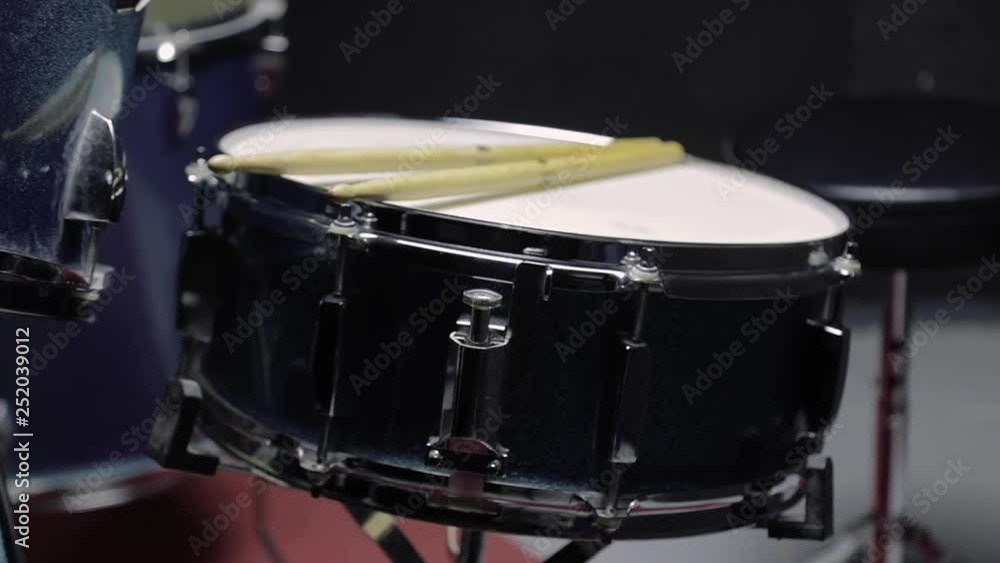 Close up video drive in to the snare drum on the black background. Close up video drive in to the snare drum on the black background.