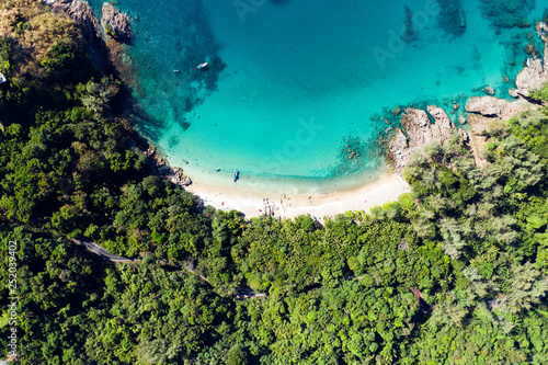 View from above, aerial view of a beautiful tropical beach with white sand and turquoise clear water, Banana beach, Phuket, Thailand.