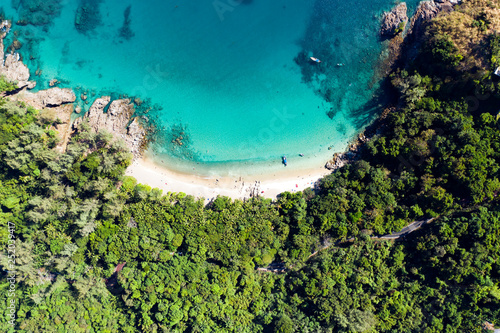 View from above, aerial view of a beautiful tropical beach with white sand and turquoise clear water, Banana beach, Phuket, Thailand.