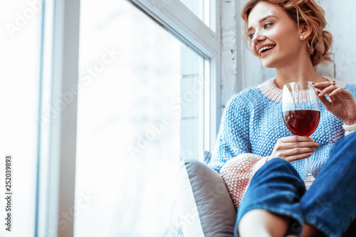 Happy delighted woman looking into the window