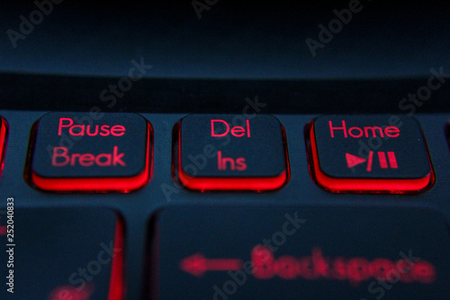 hand pressing "Backspace"  "Del" button on computer and Red LED - Image