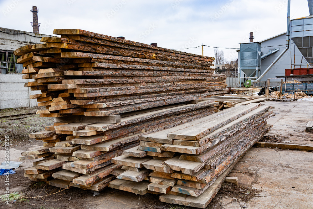 Sawmill. A stack of wooden boards in the open air. Sawing, lumber. Sawmill. A stack of wooden boards in the open air. Sawing, lumber.