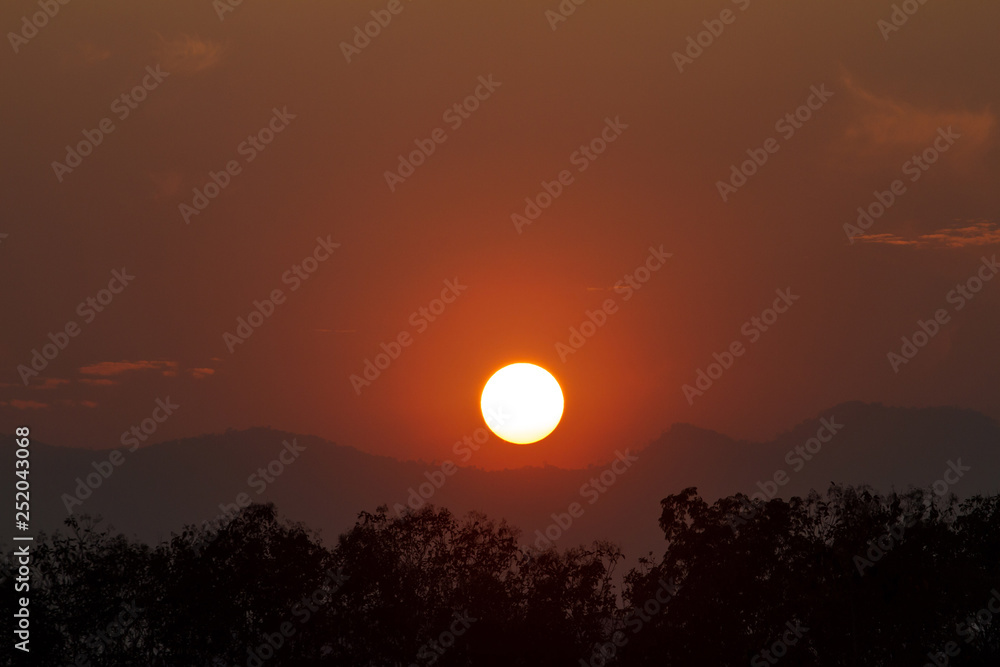 View images of the sun falling behind the mountains. View images of the sun falling behind the mountains.