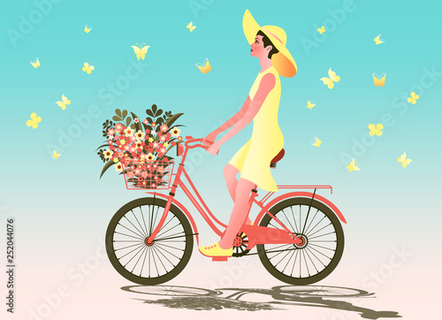 Girl on a bike with flowers in a basket and butterflies around.