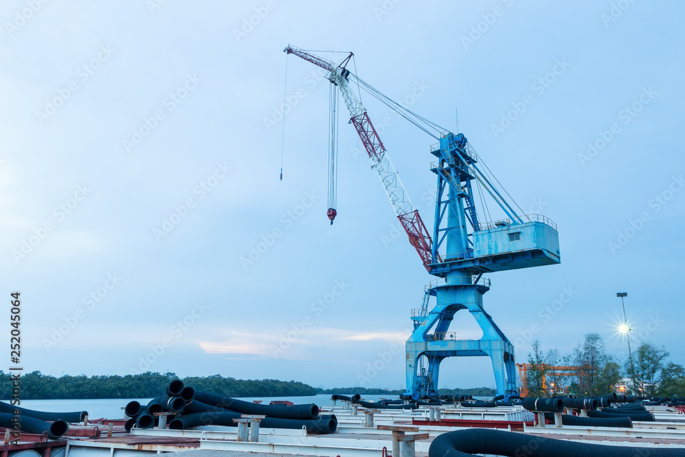 Crane in a port at sunset.