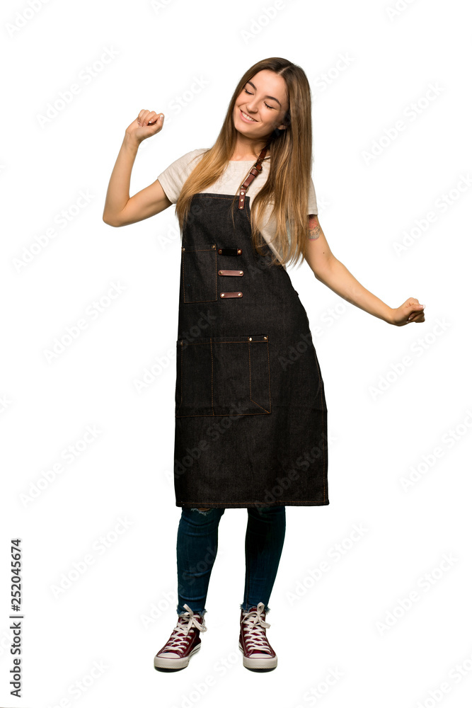 Full body Young woman with apron enjoy dancing while listening to music at a party on isolated background Full body Young woman with apron enjoy dancing while listening to music at a party on isolated background