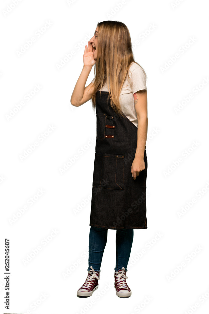 Full body Young woman with apron shouting with mouth wide open to the lateral on isolated background Full body Young woman with apron shouting with mouth wide open to the lateral on isolated background