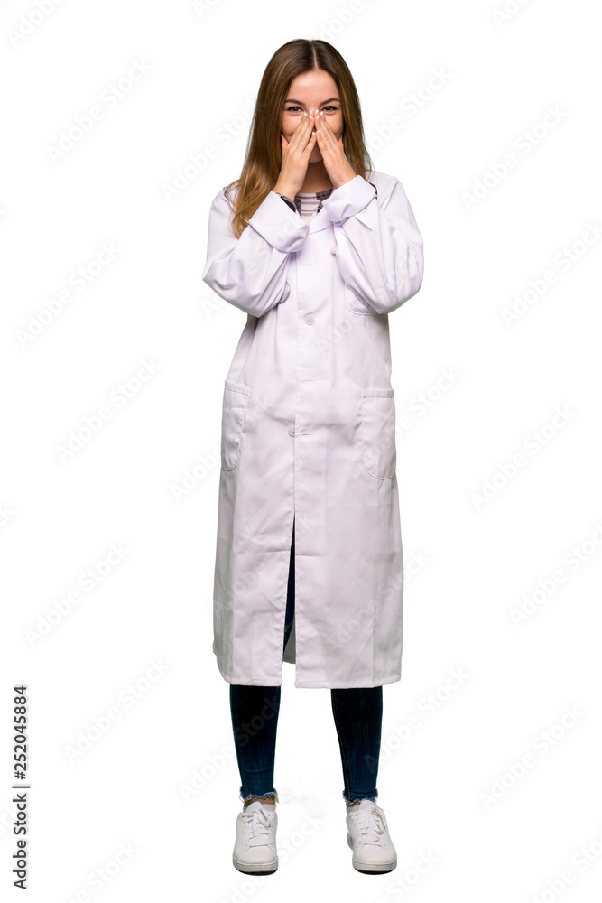 Full body Young doctor woman smiling a lot while covering mouth on isolated background Full body Young doctor woman smiling a lot while covering mouth on isolated background