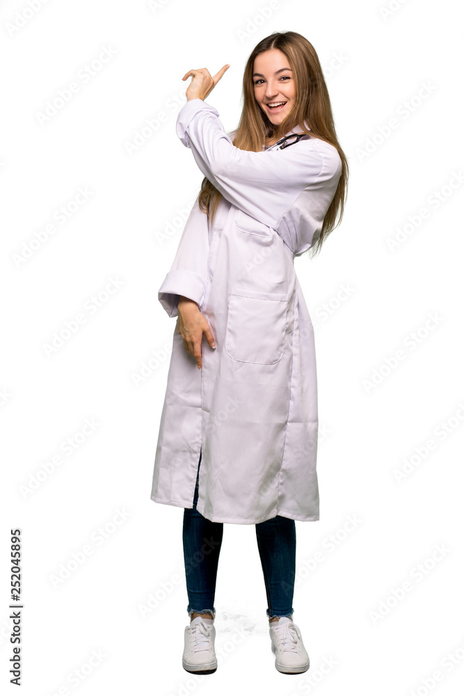 Full body Young doctor woman pointing back with the index finger on isolated background Full body Young doctor woman pointing back with the index finger on isolated background