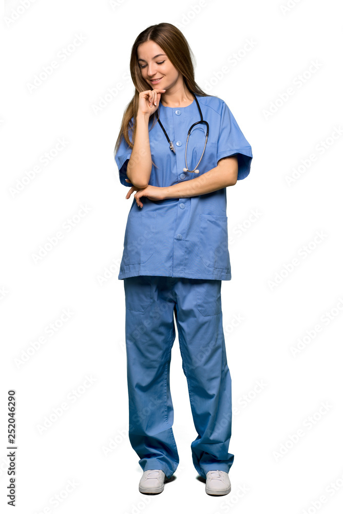 Full body Young nurse looking down with the hand on the chin on isolated background Full body Young nurse looking down with the hand on the chin on isolated background