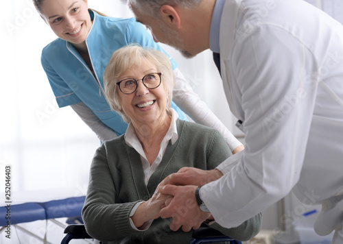 Doctor and senior patient shaking hands in the office