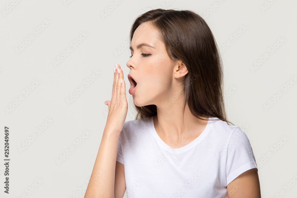 Tired funny sleepy girl student yawning isolated on background Tired funny sleepy girl student yawning isolated on background