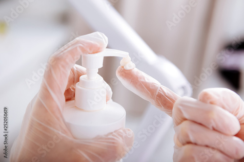 Depilatory master wearing gloves using moisturizing cream