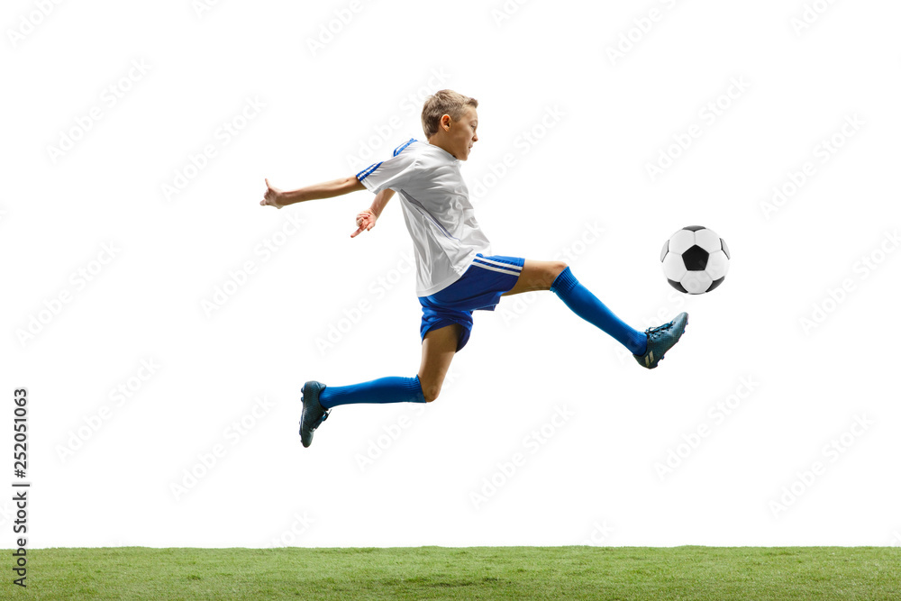 Young boy with soccer ball running and jumping isolated on white studio background. Junior football soccer player in motion Young boy with soccer ball running and jumping isolated on white studio background. Junior football soccer player in motion