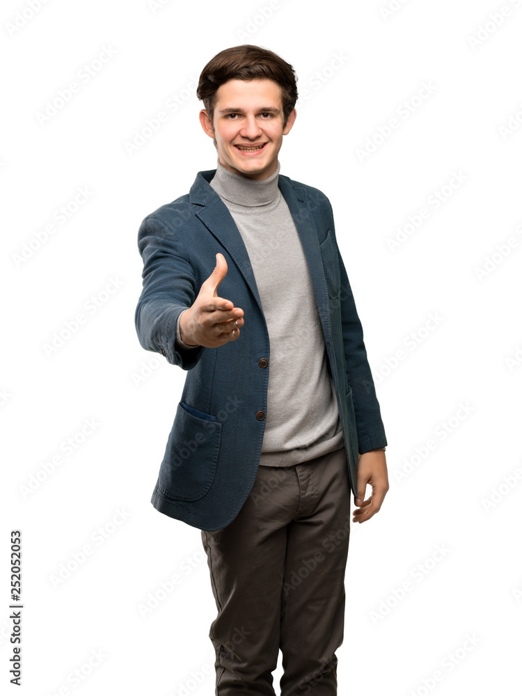 Teenager man with turtleneck shaking hands for closing a good deal over isolated white background Teenager man with turtleneck shaking hands for closing a good deal over isolated white background