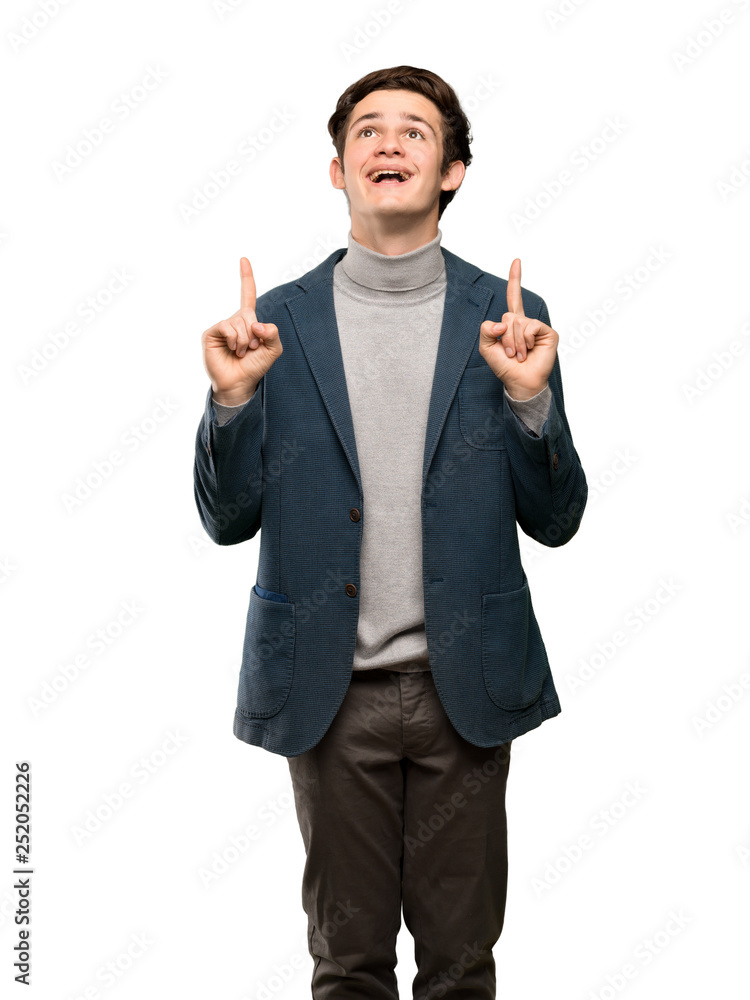 Teenager man with turtleneck surprised and pointing up over isolated white background Teenager man with turtleneck surprised and pointing up over isolated white background