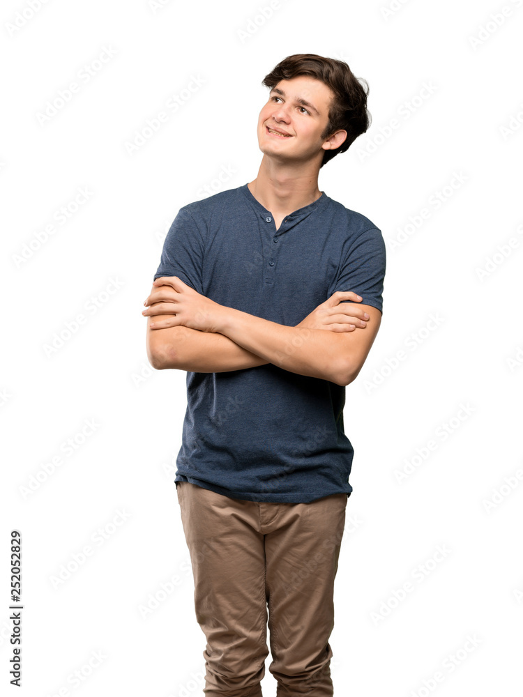 Teenager man looking up while smiling over isolated white background Teenager man looking up while smiling over isolated white background