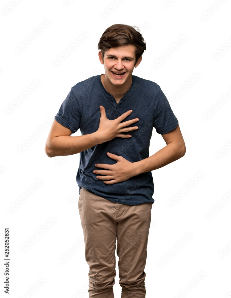 Teenager man smiling a lot over isolated white background