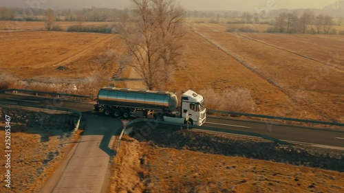 Dolly shot of a fuel truck driving on a sunny day photo