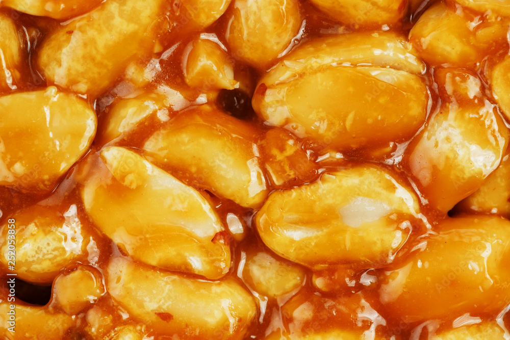 Kozinaki from golden, roasted peanuts beans as a background, texture. Macro shooting, close-up. Place for text Kozinaki from golden, roasted peanuts beans as a background, texture. Macro shooting, close-up. Place for text