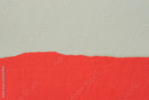 piece of creased red paper on gray background texture
