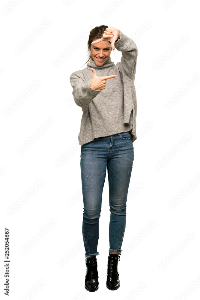 A full-length shot of a Blonde woman with turtleneck focusing face. Framing symbol over isolated white background A full-length shot of a Blonde woman with turtleneck focusing face. Framing symbol over isolated white background