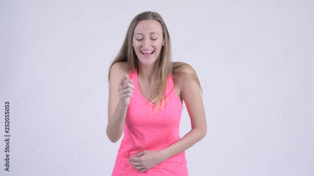 Portrait of happy blonde woman laughing and pointing at camera Portrait of happy blonde woman laughing and pointing at camera