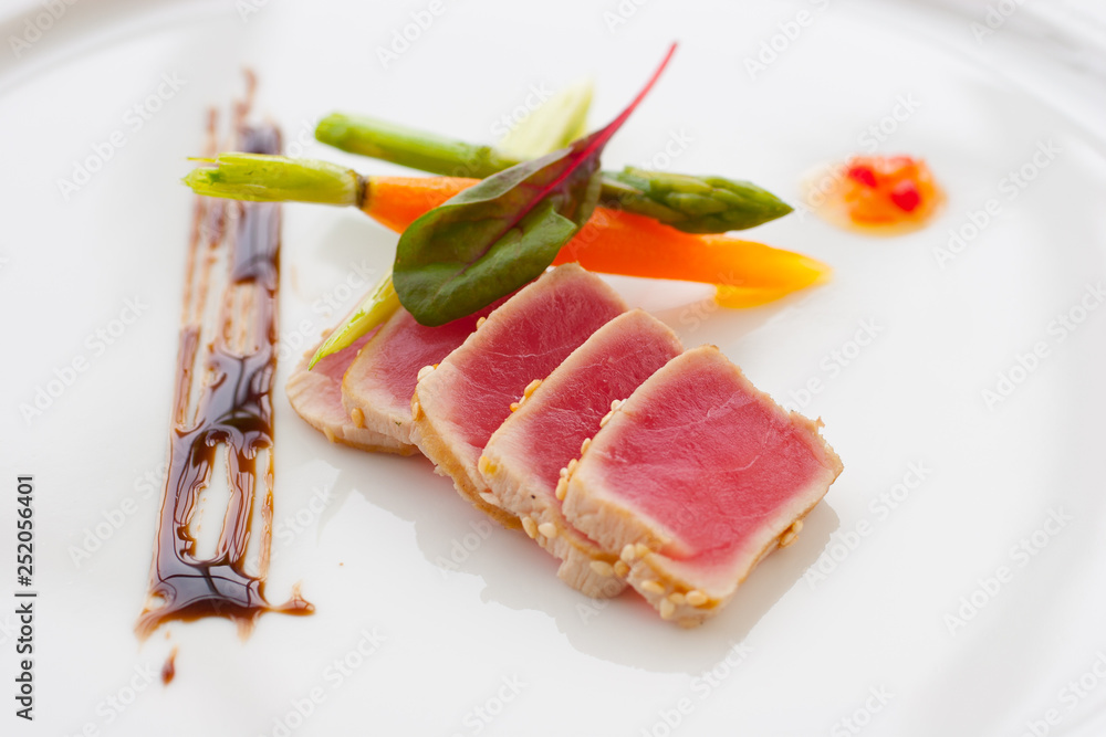 Seared Ahi Tuna Sliced on a white plate Seared Ahi Tuna Sliced on a white plate