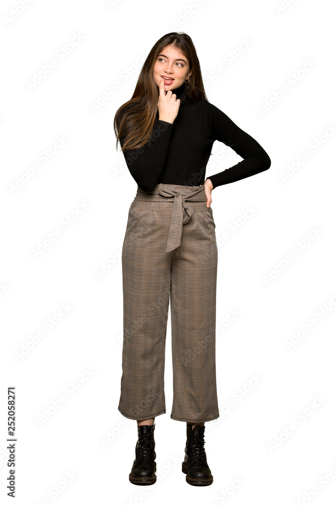 Full-length shot of Pretty girl having doubts while looking up on isolated white background Full-length shot of Pretty girl having doubts while looking up on isolated white background