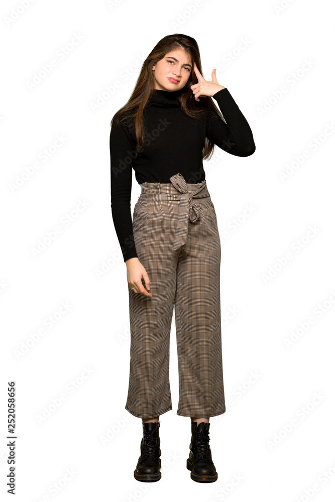 Full-length shot of Pretty girl making the gesture of madness putting finger on the head on isolated white background Full-length shot of Pretty girl making the gesture of madness putting finger on the head on isolated white background
