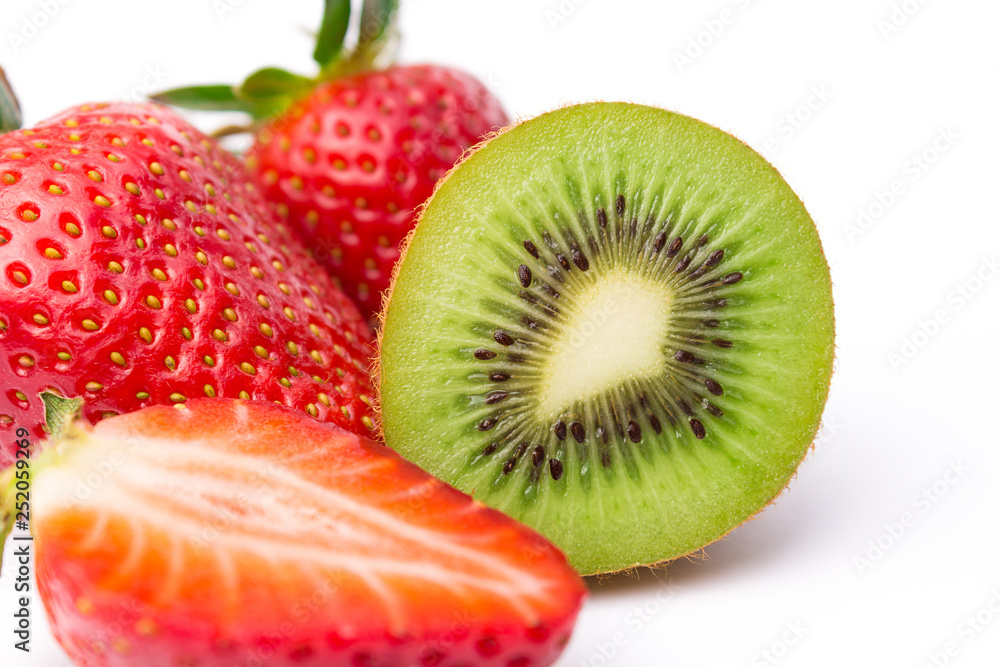Halved kiwi fruit with strawberries on white Halved kiwi fruit with strawberries on white