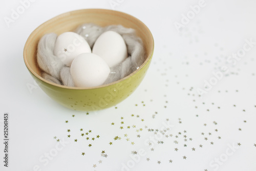 Easter. Easter eggs. Bokeh. Silver. Bowl with eggs